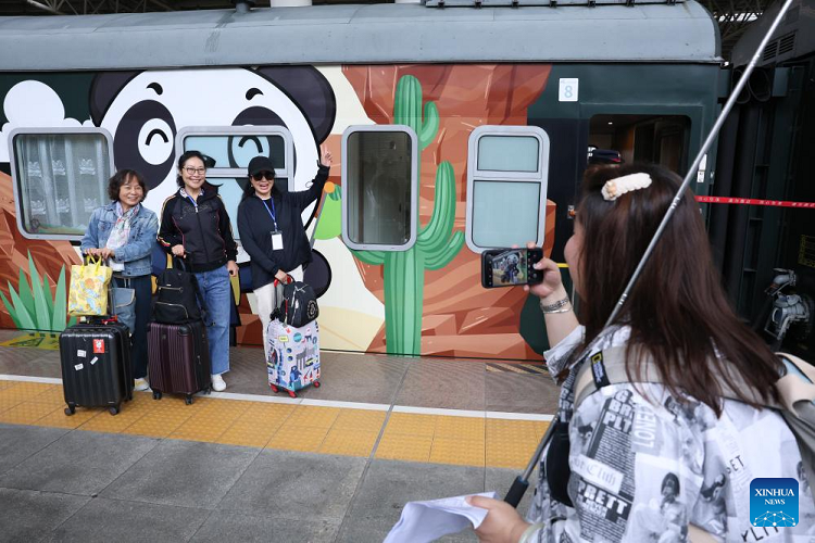 Passengers posing beside the Panda Train at Guiyang on 8 May 2024